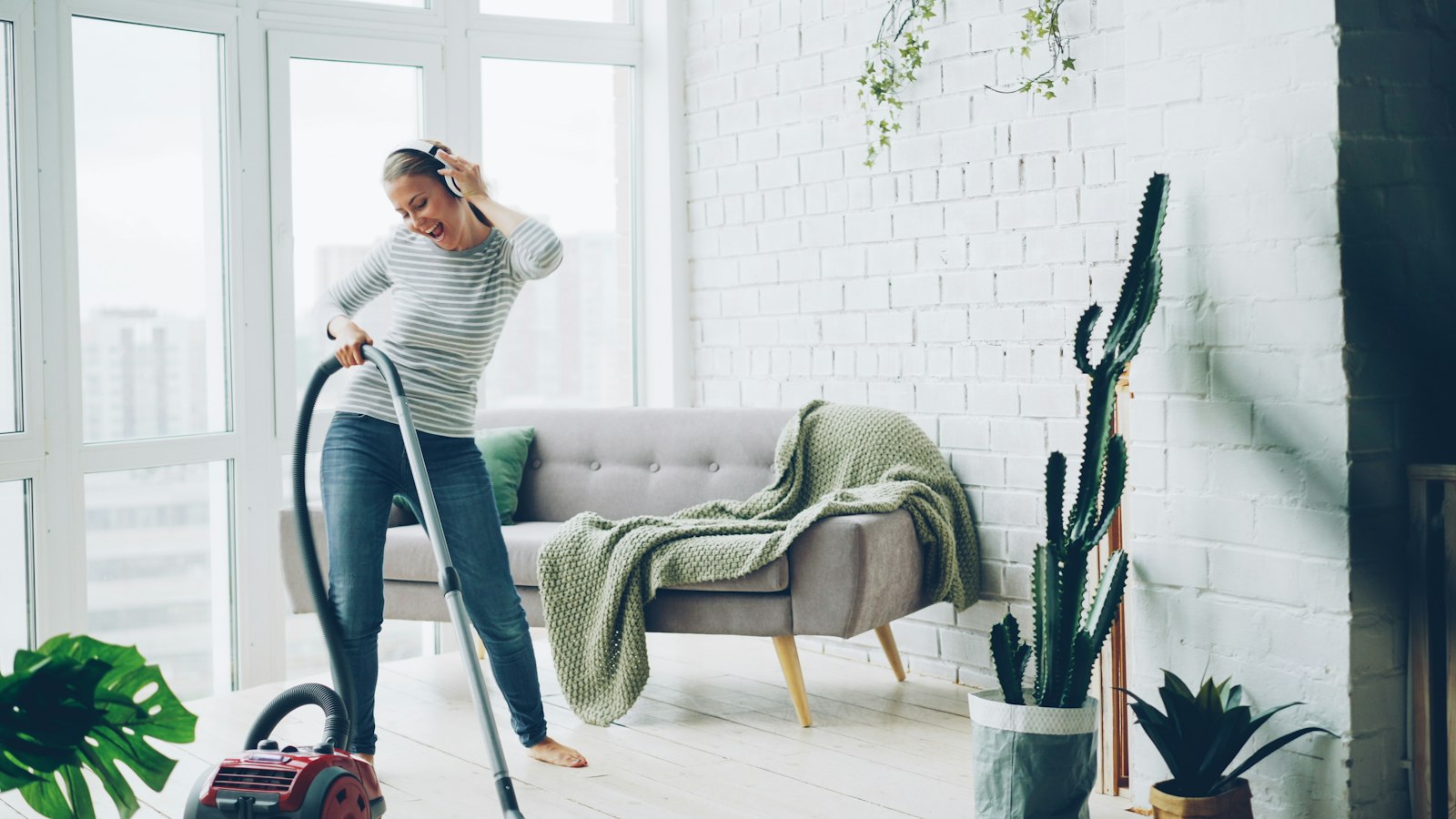 Vacuuming a bright living room during a domestic clean